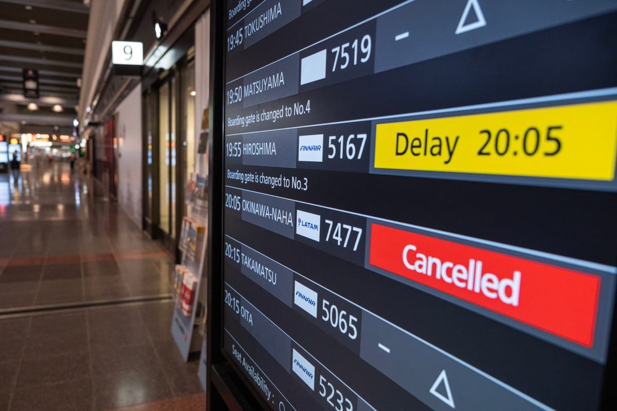 A departures board shows a cancelled flight to Okinawa after Severe Tropical Storm Jangmi shut down the airport there as it moved toward mainland Japan, at Haneda Airport in Tokyo on June 1, 2026, as airlines began suspending service across the region. (P