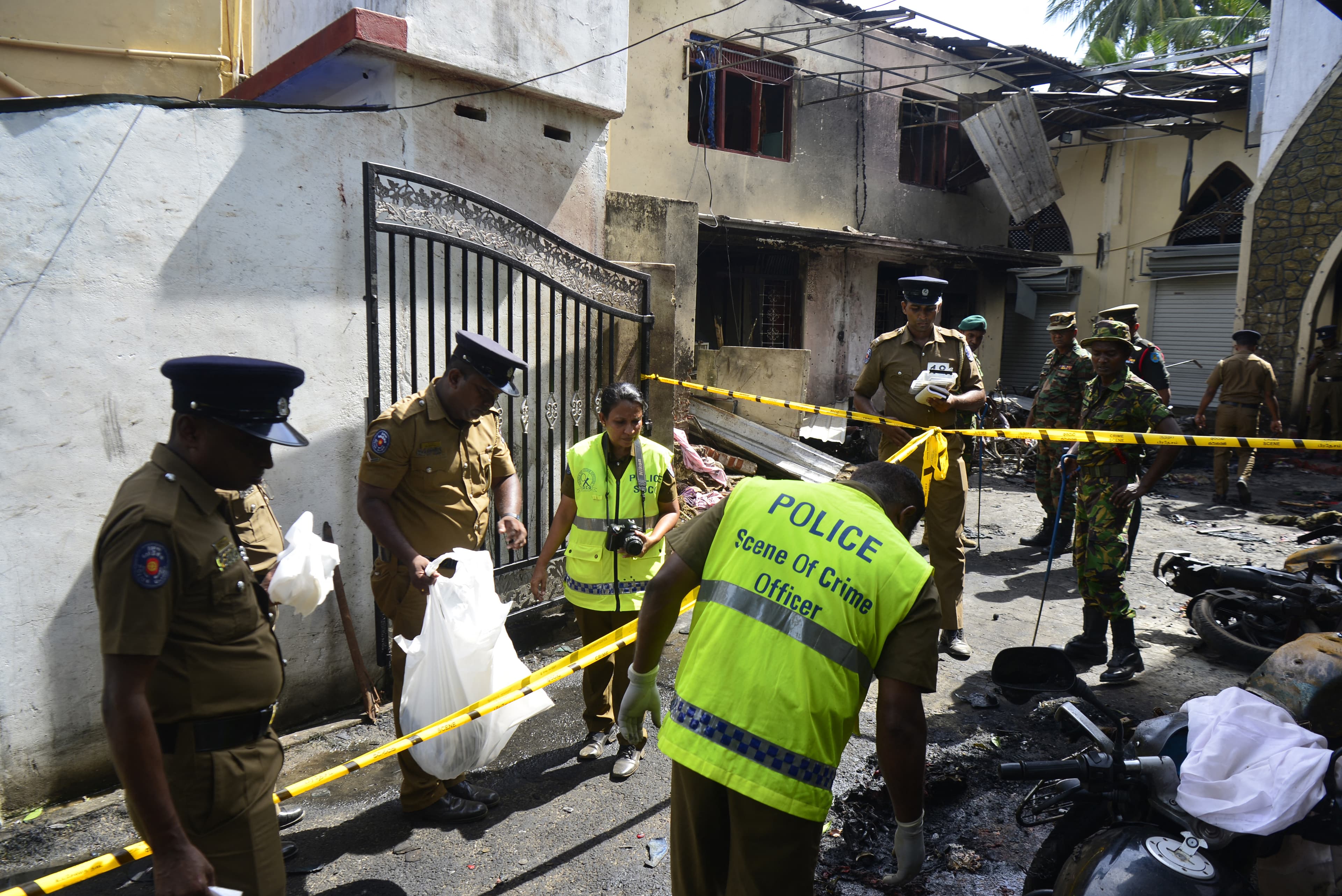 Sri Lankan security personnel and police investigators look through debris outside Zion Church following an explosion in Batticaloa in eastern Sri Lanka on April 21, 2019. (AFP)