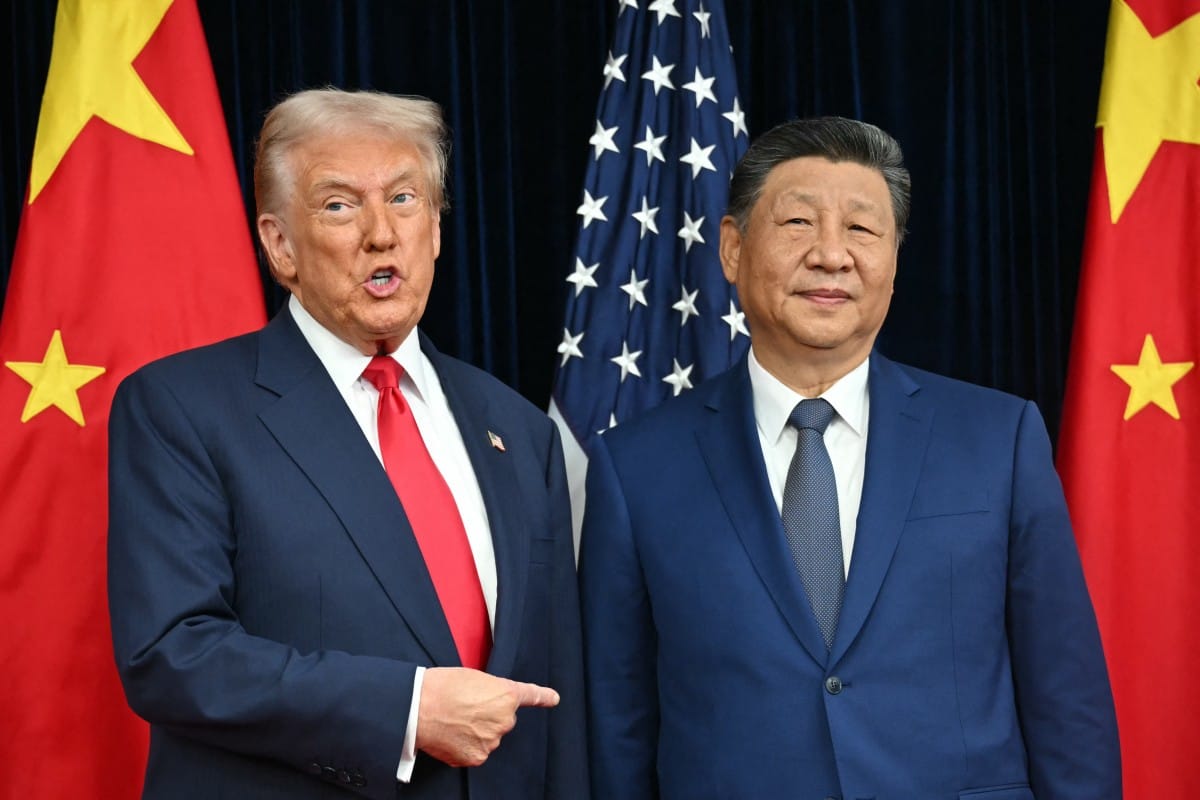 US President Donald Trump (L) and China's President Xi Jinping greet each other as they arrive for talks at the Gimhae Air Base, located next to the Gimhae International Airport in Busan on October 30, 2025. (AFP)