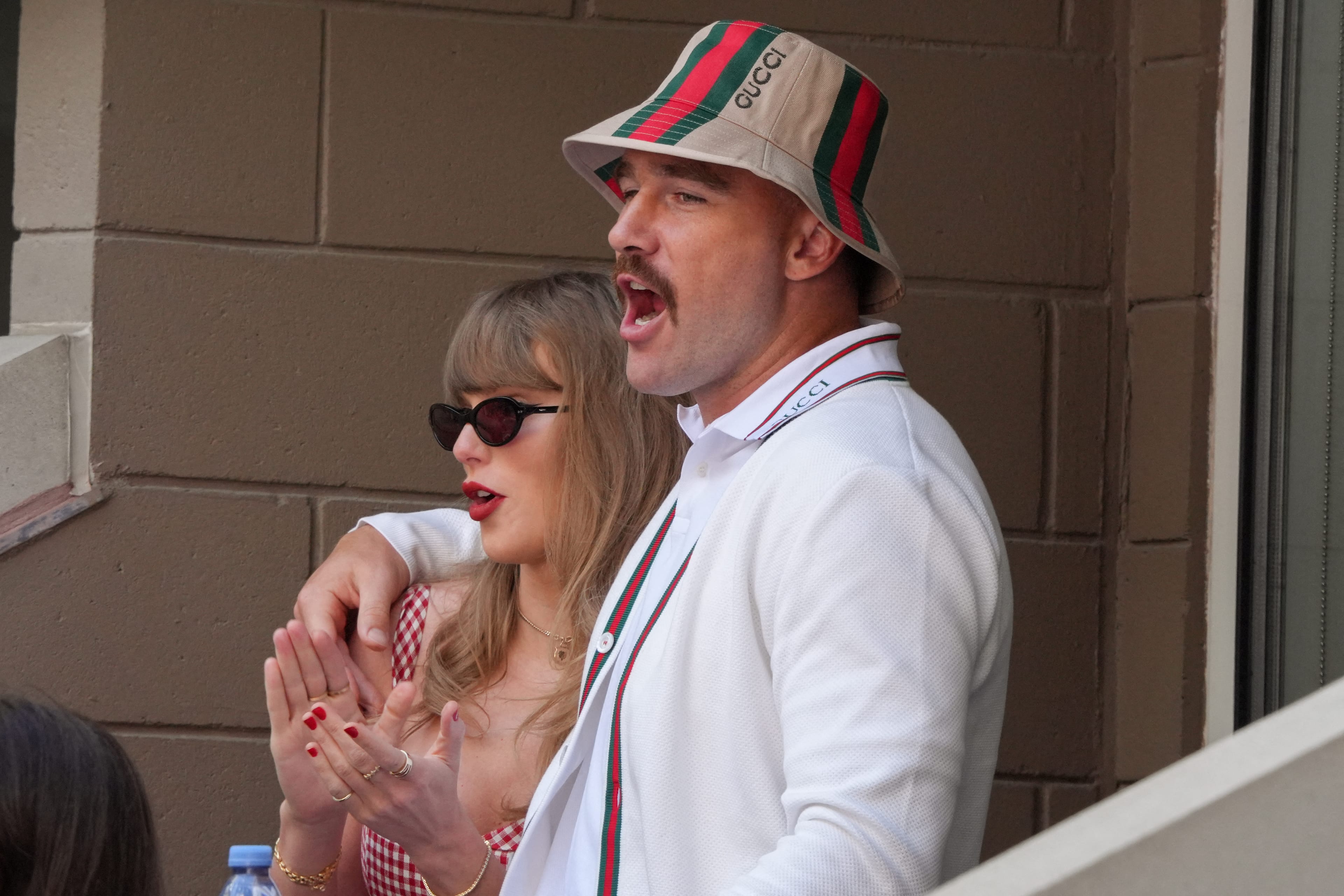 US musician Taylor Swift (L) and US NFL football player Travis Kelce attend the men's final match between Italy's Jannik Sinner and USA's Taylor Fritz on day fourteen of the US Open tennis tournament at the USTA Billie Jean King National Tennis Center in