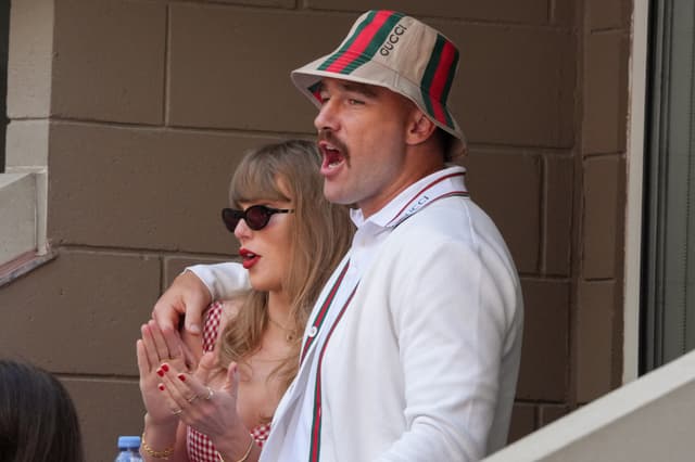 US musician Taylor Swift (L) and US NFL football player Travis Kelce attend the men's final match between Italy's Jannik Sinner and USA's Taylor Fritz on day fourteen of the US Open tennis tournament at the USTA Billie Jean King National Tennis Center in