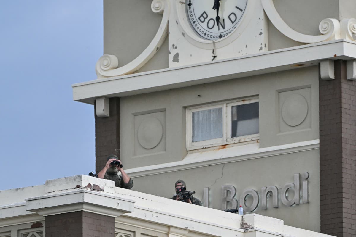 Police snipers are seen on a roof as they secure the area during the memorial held for the victims of a shooting at Bondi Beach in Sydney on December 21, 2025 (AFP)