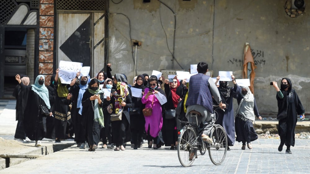 Afghan women hold placards as they march to protest for their rights, in Kabul on April 29, 2023. Afghan women protested in Kabul on April 29, defying a dissent crackdown to voice opposition to foreign nations formally recognizing the Taliban government.