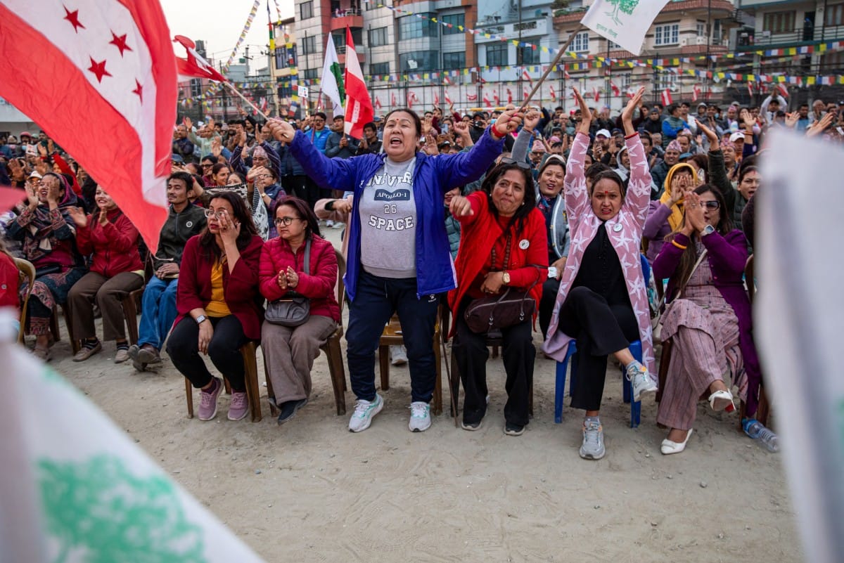 Supporters waving flags attend a campaign rally of Nepali Congress party president and election candidate Gagan Thapa in Kathmandu on March 1, 2026 ahead of parliamentary elections in Nepal. (Photo by Prabin RANABHAT / AFP)