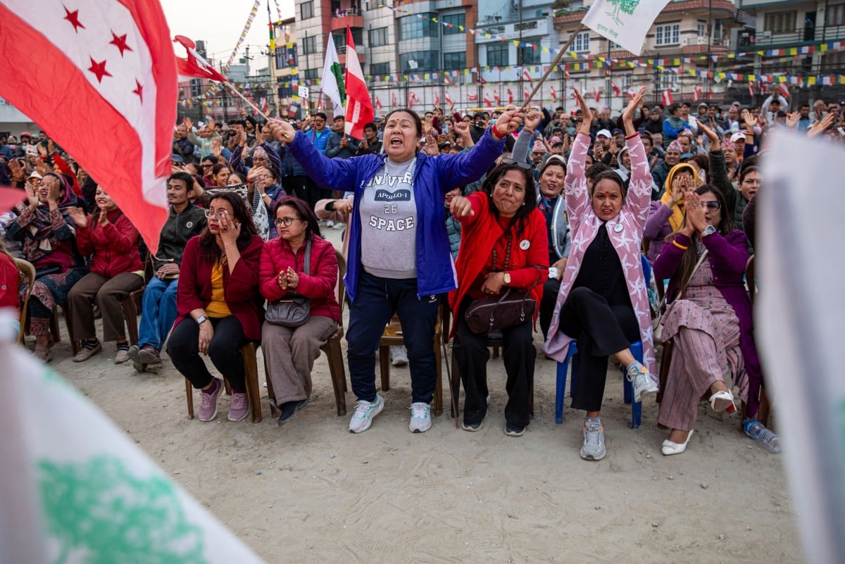 Supporters waving flags attend a campaign rally of Nepali Congress party president and election candidate Gagan Thapa in Kathmandu on March 1, 2026 ahead of parliamentary elections in Nepal. (Photo by Prabin RANABHAT / AFP)
