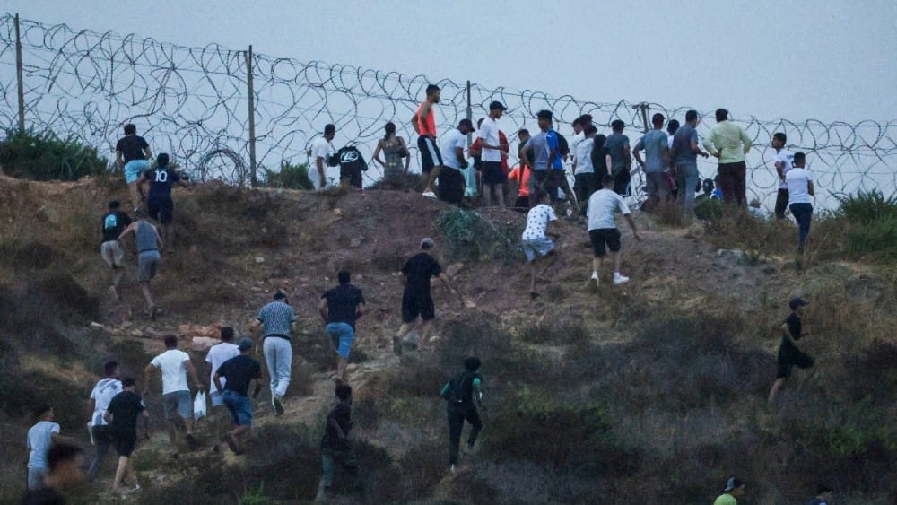 People gather on a hilltop near Bab Sebta on the Morocco-Spain border, near Spain's enclave of Ceuta and the Moroccan town of Fnideq on July 30, 2026 (AFP)