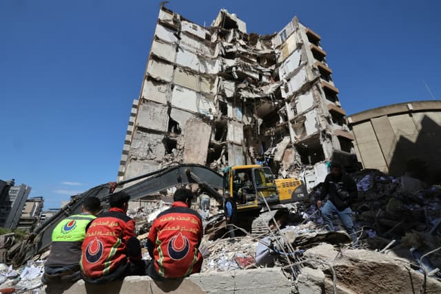 Lebanese rescuers clear the rubble at the site of an Israeli airstrike that targeted a building the day before in the Lebanese Beirut on April 9, 2026. (AFP)