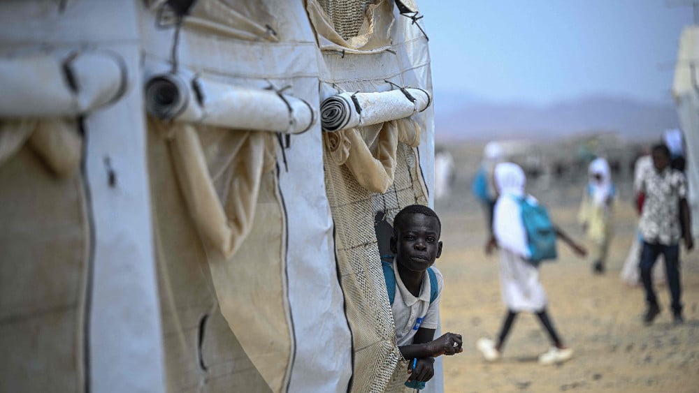 A displaced Sudanese student looks out from a tent at an elementary school run by the Sudanese Coalition for Education in partnership with the United Nations International Children's Emergency Fund (UNICEF), south of Port Sudan, on April 26, 2026. (AFP)