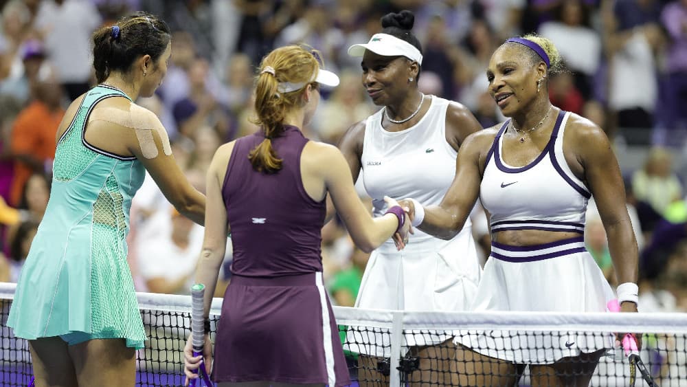 USA's Serena Williams (R) and her sister Venus Williams (2R) shake hands with Australia's Maya Joint (2L) and Taiwan's Chan Hao-ching (L) after losing their women's doubles first-round tennis match on day six of the US Open tennis tournament. (AFP)