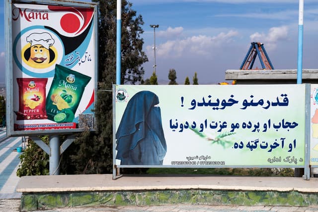 A poster in Kabul reads: ‘Dear sisters! Hijab and veil are your dignity and are in your benefit in this world and in the hereafter’. (AFP)