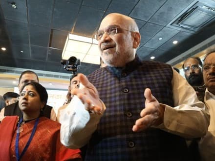 Indian Home Minister interacts with poll worker after implementation of the controversial Special Intensive Revision (SIR)