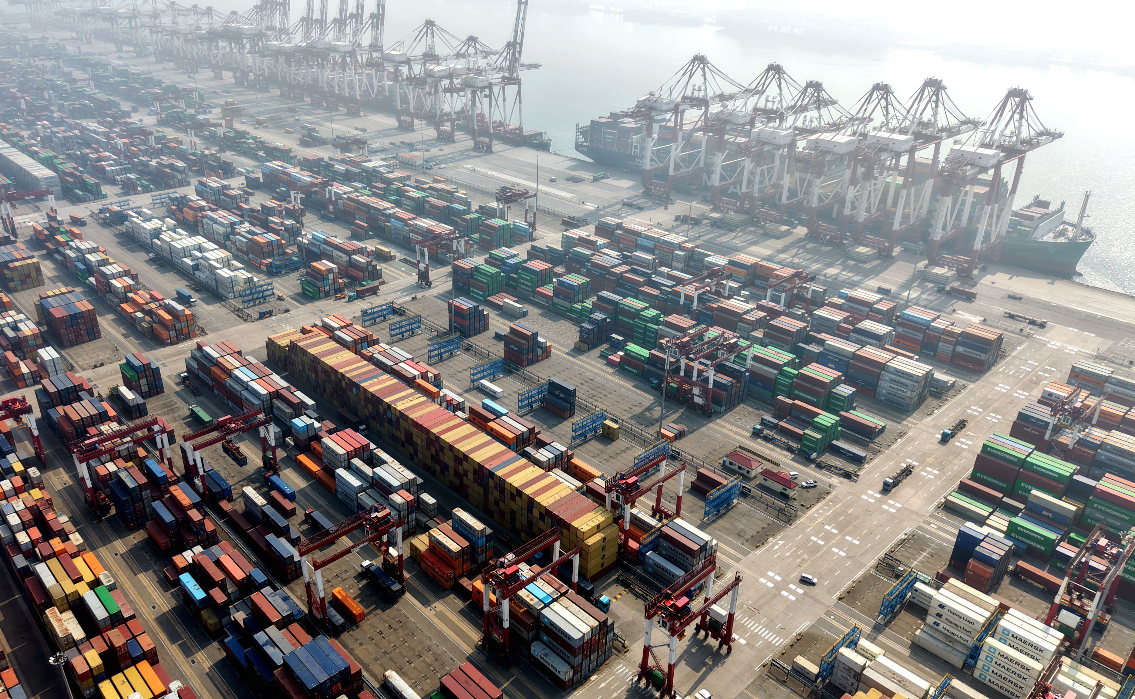 Cargo ships and containers are seen at the container terminal of the port in Qingdao, in China’s eastern Shandong province on April 2, 2026.