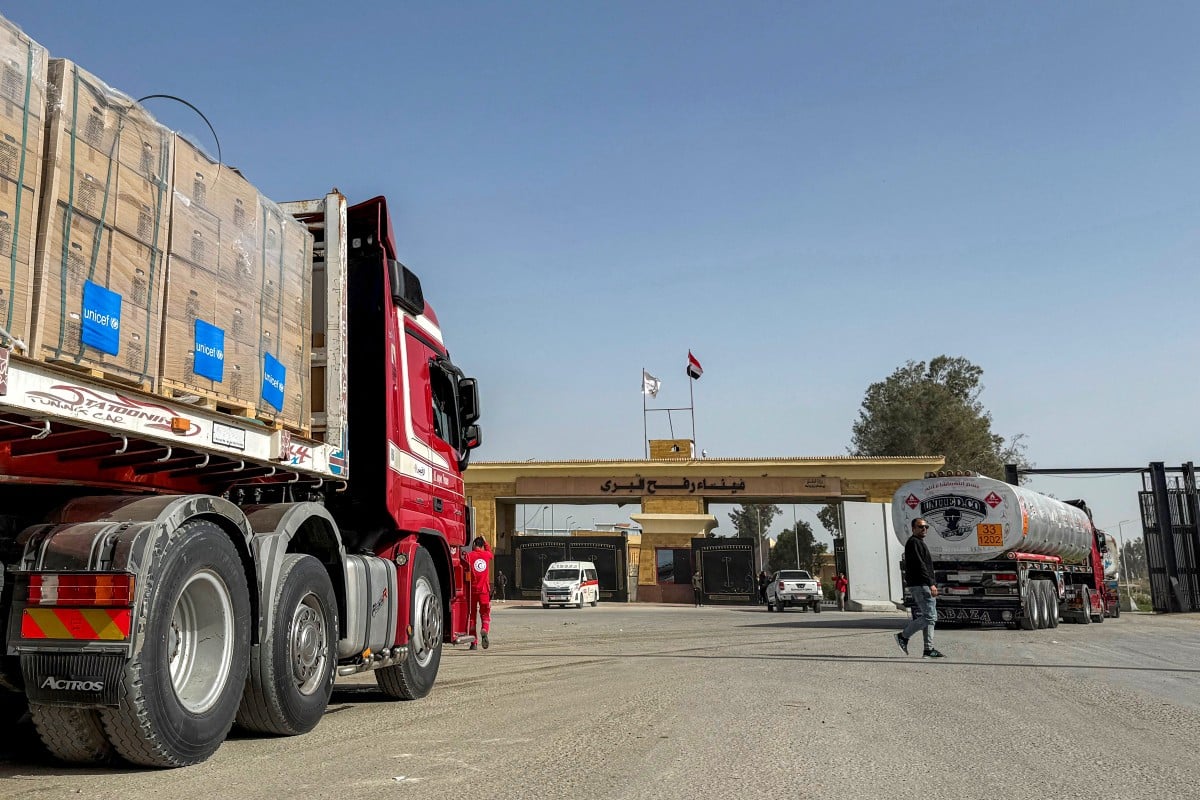 Fuel and humanitarian aid trucks enter through the Egyptian side of the Rafah border crossing with the Gaza Strip in northeastern Egypt on January 27, 2026, as the vital crossing to the Palestinian territory reopens. (AFP)
