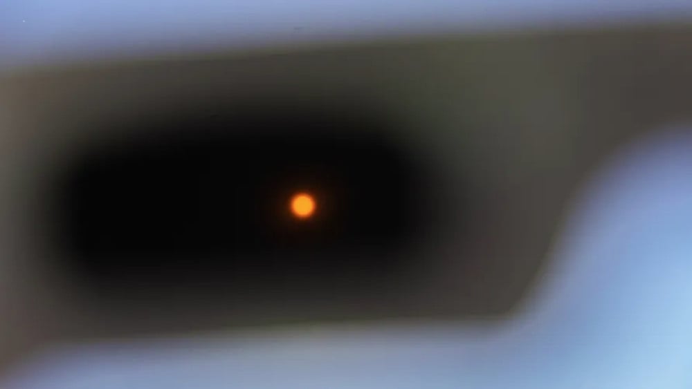 A view of the sun through the opaque lenses of a pair of special cardboard sunglasses designed to protect the eyes while watching the solar eclipse on August 12 in Saint-Pol-de-Leon, in the Finistere department of Brittany in western France, on August 1,
