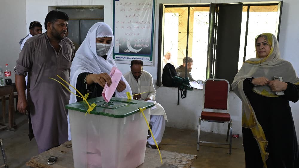 A woman casts her ballot at a polling station during the first phase of regional elections in Mirpur, Azad Jammu and Kashmir on July 27, 2026. (AFP)