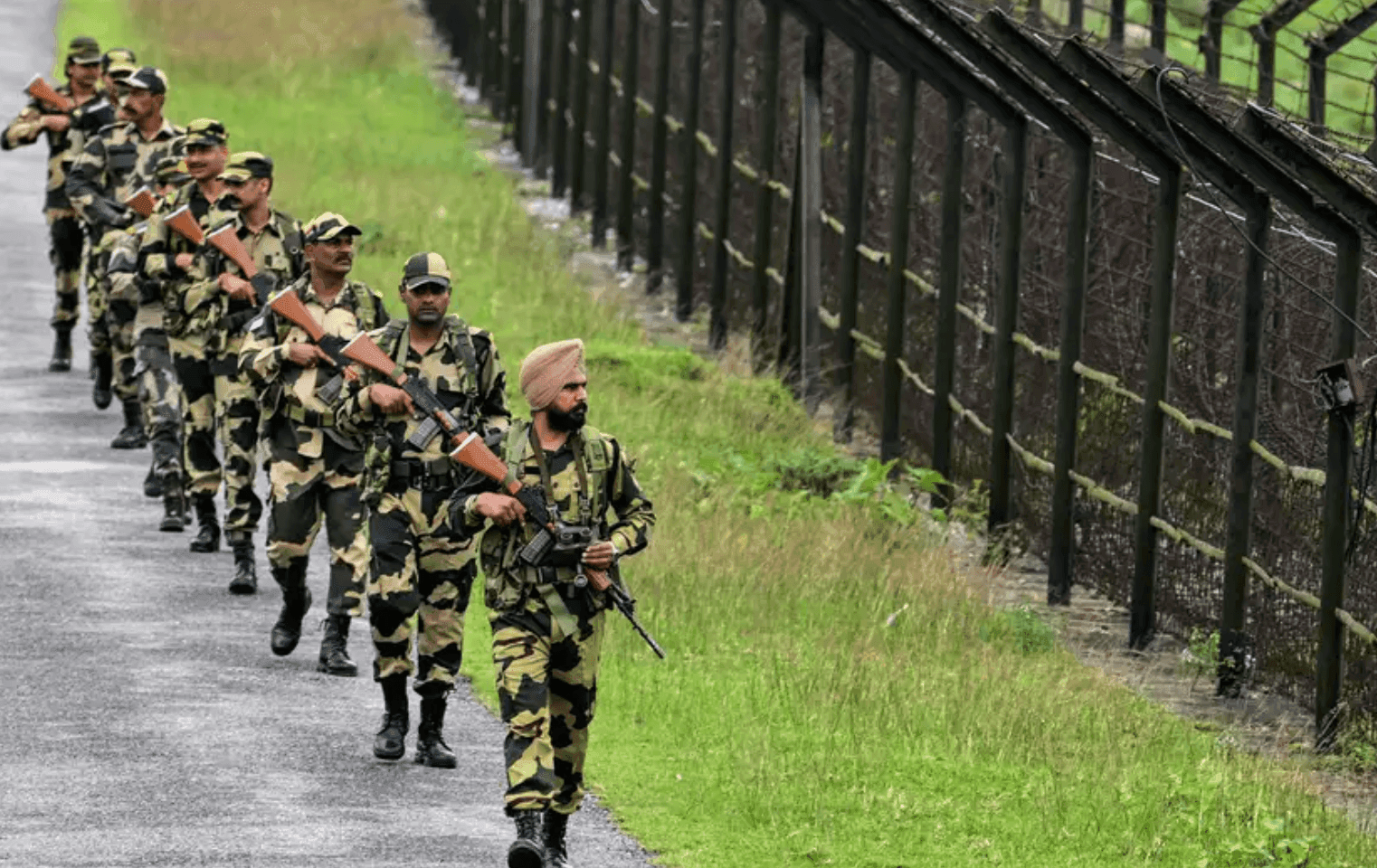 FILE: Indian troops patrolling the border fence with Bangladesh in India's Assam state in May 2025. (Photo: Biju Boro/AFP)
