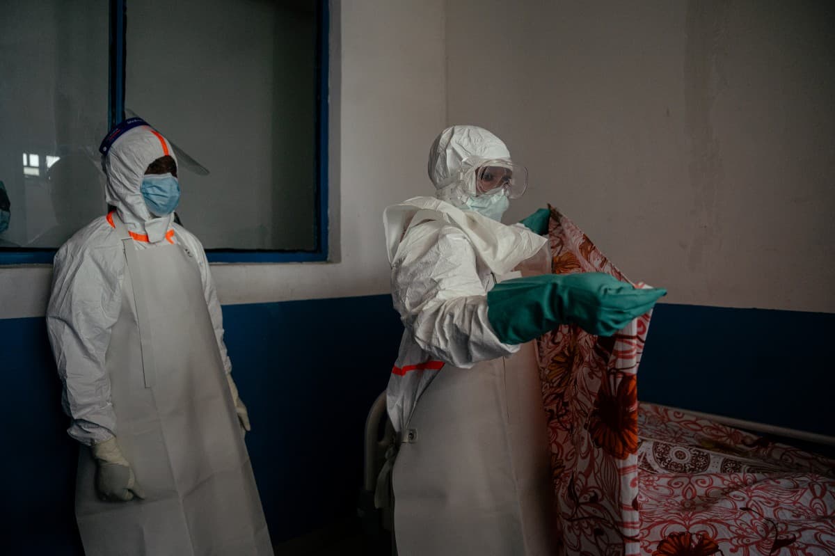 Medical personnel at CBCA Virunga Hospital wear gowns, masks, and protective gear as they prepare an isolation room for a female patient placed under 21-day observation in the suspected cases area in Goma, on May 21, 2026.