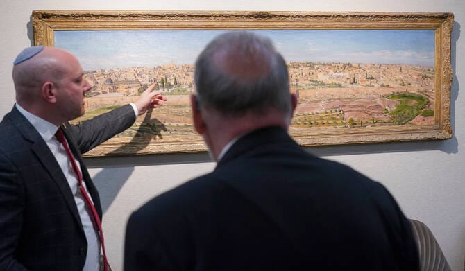 US Ambassador to Israel Mike Huckabee (R) is shown a painting of Jerusalem during a visit to the Beit Hanassi presidential residence, in Jerusalem, on September 15, 2025.