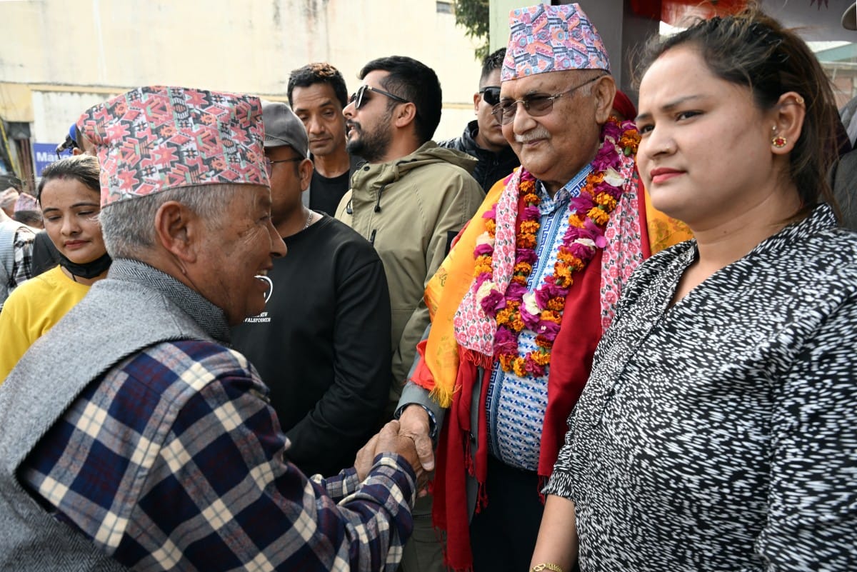 Khadga Prasad Sharma Oli (2L), Nepal's former prime minister and Communist Party of Nepal-Unified Marxist Leninist (CPN-UML) leader, greets supporters during a door-to-door election campaign rally in Damak, Jhapa district on February 16, 2026. (AFP)