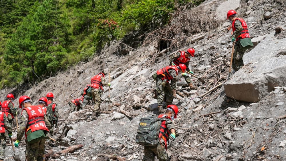 Paramilitary police conduct search and rescue operations on a hillside 2 kilometers from Gyirong Port which was damaged after a mudslide two days earlier, in Gyirong County, in China’s western Tibet region on August 28, 2026. (AFP)