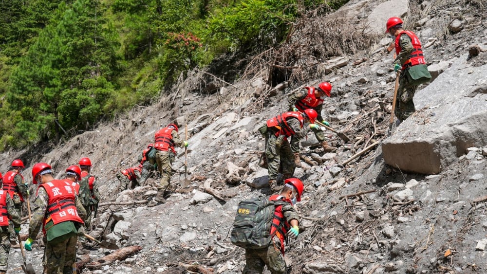 Paramilitary police conduct search and rescue operations on a hillside 2 kilometers from Gyirong Port which was damaged after a mudslide two days earlier, in Gyirong County, in China’s western Tibet region on August 28, 2026. (AFP)