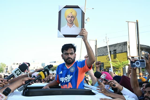 Cockroach Janta Party (CJP) founder Abhijeet Dipke (C) holds a portrait of Shaheed Bhagat Singh while he protests over alleged irregularities in the country's major examinations, in Amritsar on June 13, 2026. (Photo by Narinder NANU / AFP)