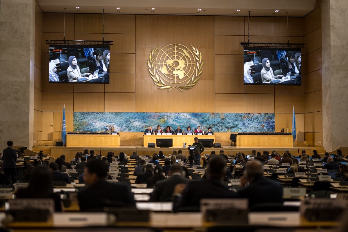 A representative of Qatar is seen on screens as he delivers a speech on human rights in the Islamic Republic of Iran during a session of the UN Human Rights Council, in Geneva on March 16, 2026. (Photo by Fabrice COFFRINI / AFP)