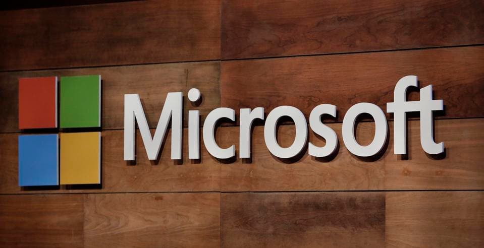 Microsoft logo displayed at the company’s annual shareholder meeting, with the stage and branding visible in the background.