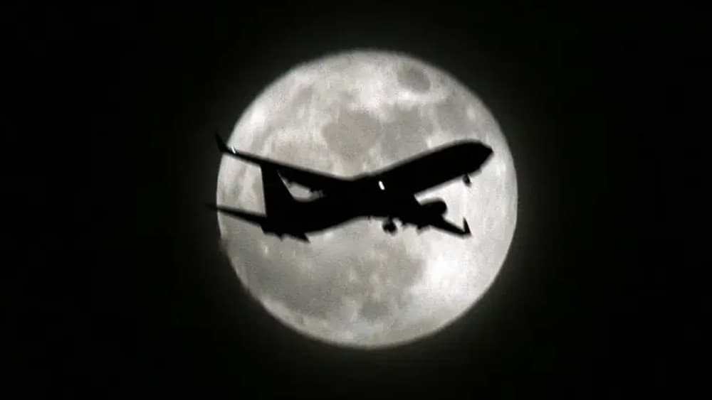 An airplane flies past the full moon over the Indian capital in New Delhi on May 20, 2008. (AFP/File)