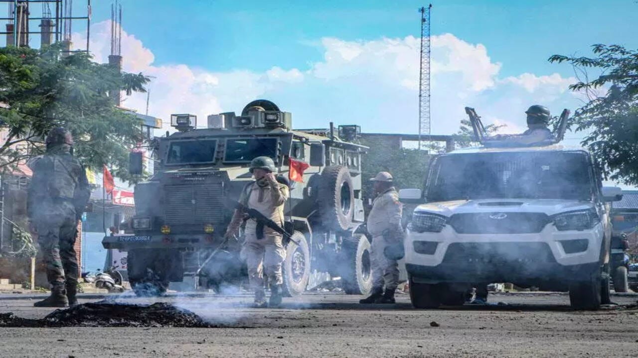 Security vehicles are positioned in the middle of a road, during a curfew in Imphal on June 9, 2025. (AFP)