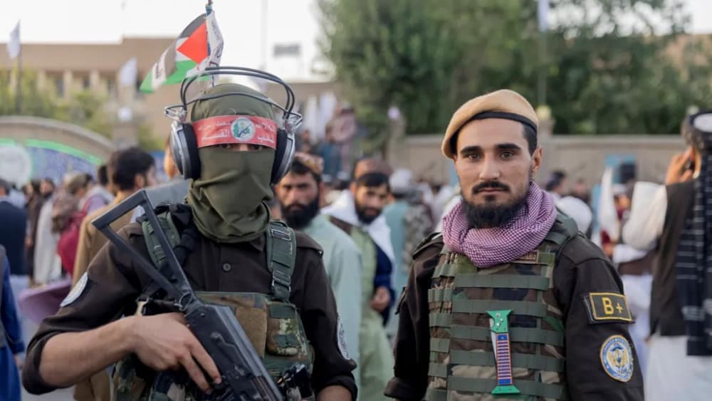 Taliban fighters stand for a photo on a street during celebrations for the fifth anniversary of the Taliban's takeover in Herat, Afghanistan, on August 15, 2026. (AFP)