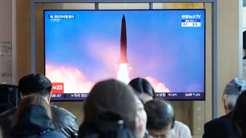 A TV screen shows a file image of North Korea's missile launch during a news program at Seoul Railway Station in Seoul, South Korea, Wednesday, Oct. 22, 2025. (AP Photo/Ahn Young-joon)