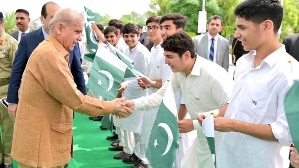 Prime Minister Muhammad Shehbaz Sharif interacts with young students at an event organised to celebrate International Youth Day on August 12, 2024. (File photo: APP)