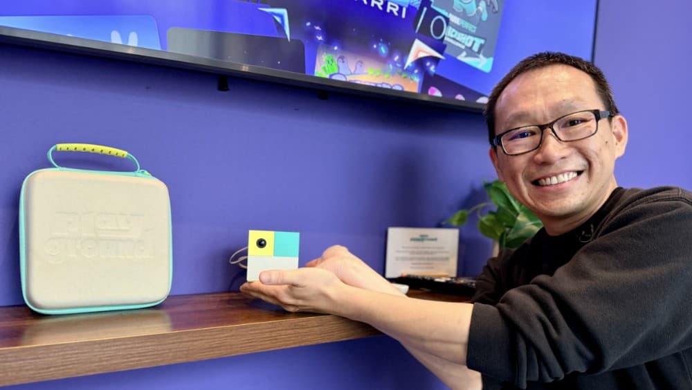 David Lee, CEO and co-founder of US company Nex Playground poses with his new gaming console "Nex" after an interview with AFP, poses on August 27, 2026 during the Gamescom video games trade fair on the fair grounds in Cologne, western Germany. (Photo by