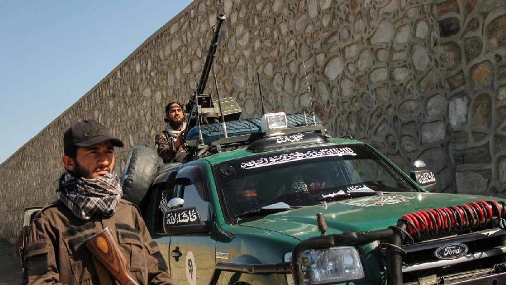 Taliban security personnel manning anti-aircraft gun patrol in a vehicle amid the ongoing clashes between Afghanistan and Pakistani forces in the Momand Dara district of Nangarhar province on March 13, 2026.