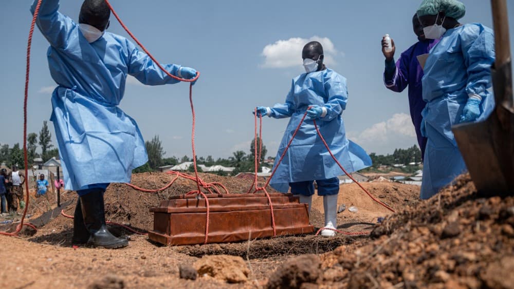 Teams from the International Federation of the Red Cross and Red Crescent Societies prepare for burial at Mbiyo cemetery the body of a fourth orphan who died from Ebola virus disease at an orphanage in Bunia, Ituri Province, June 19, 2026 (Photo by JOSPIN