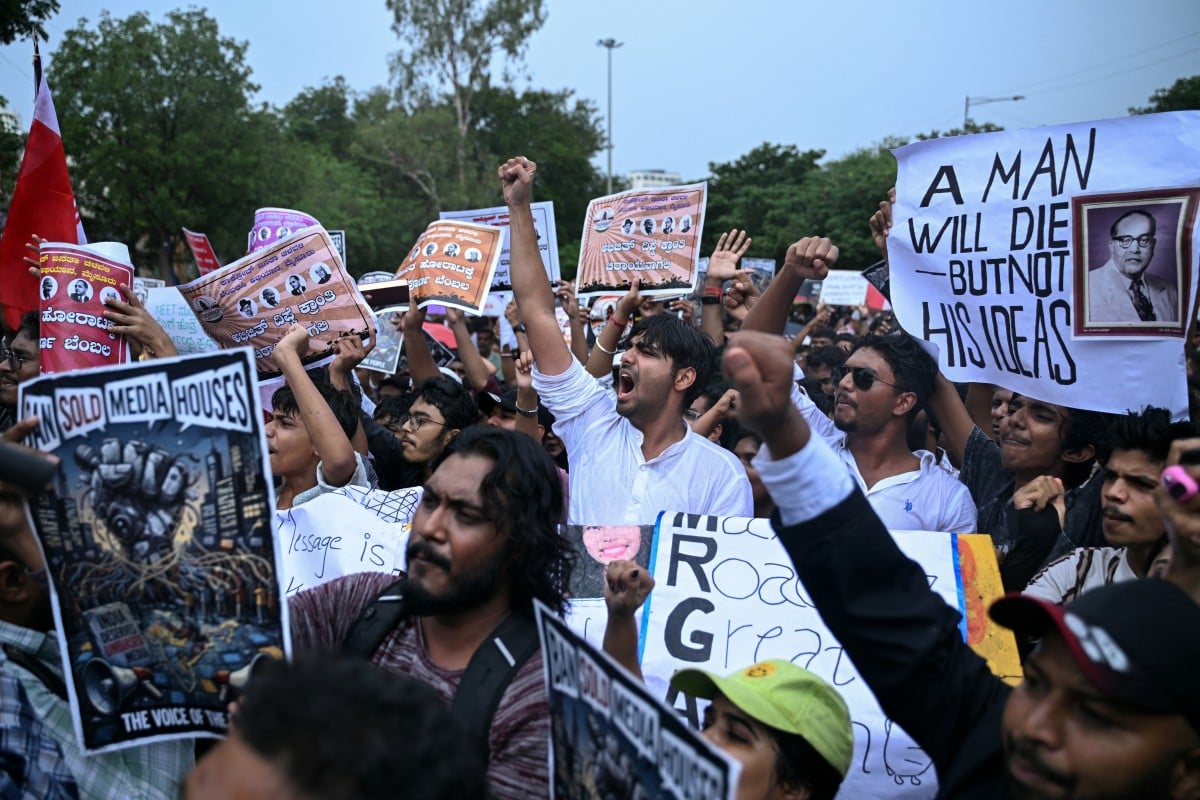 India's Cockroach Janta Party (CJP) activists hold placards and shout slogans during a protest against alleged irregularities in country's major examinations at Freedom Park in Bengaluru on June 14, 2026. (Photo by Idrees MOHAMMED / AFP)