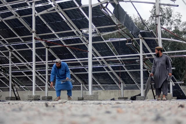Afghan men inspect the damaged rooftop of the Faculty of Education building at the Sayed Jamaluddin University in Asadabad, Kunar province. (AFP)