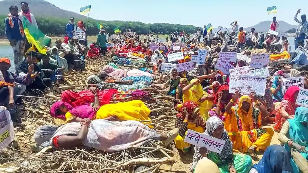 Indigenous villagers in India lie on funeral pyres to stop dam construction